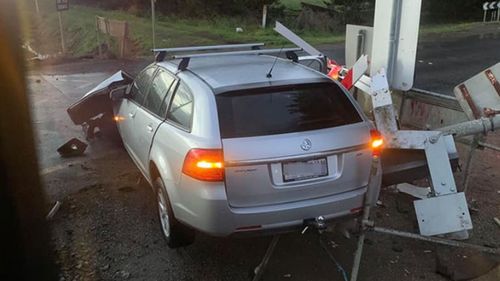 The vehicle was hit by the train and pushed into the boom gate. 