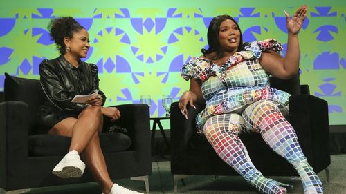Lizzo, right, and iHeart Media's Angela Yee take part in a keynote speech at the Austin Convention Center during the South by Southwest Music Festival on Sunday, March 13, 2022, in Austin, Texas.