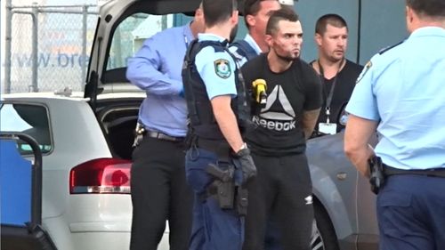 Heavily armed officers surrounded a white Audi and two men were arrested in a raid at Narellan, including 26-year-old Adis Hamidovic who sustained a large facial wound in the scuffle. (9NEWS)