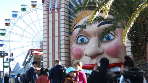 Guests queue to enter Luna Park on  a July day in Sydney, Australia.