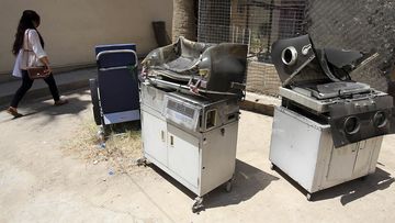 Burned incubators for newborn babies are dumped outside a maternity ward after a fire at Yarmouk hospital in western Baghdad. (AAP)
