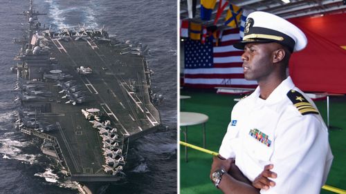 An officer from the USS Carl Vinson prepares to welcome Vietnamese visitors. (AP).