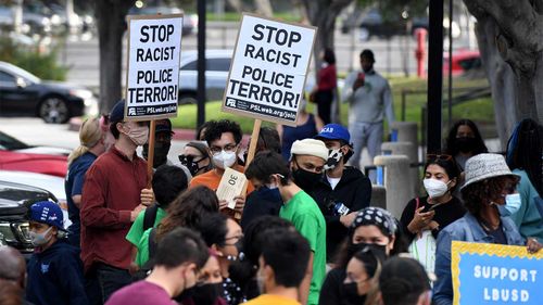 A crowd gathered October 6 in Long Beach, California, to learn that the school board unanimously voted to terminate a school safety officer involved in a deadly shooting.