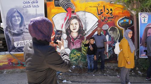 Palestinians visit the site where veteran Palestinian-American reporter Shireen Abu Akleh was shot and killed, in the West Bank city of Jenin, May 18, 2022.  The Al Jazeera news network says it will submit a case file to the International Criminal Court on the killing of reporter Shireen Abu Akleh, who was shot dead earlier this month during an Israeli raid in the occupied West Bank. (AP Photo/Majdi Mohammed, File)