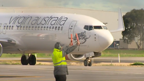 A passenger on board a Virgin Australia aircraft has tested positive for COVID-19 after arriving in Adelaide.