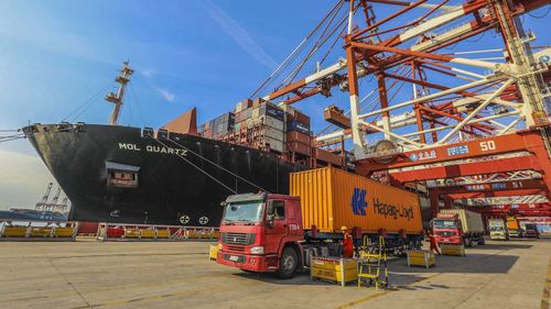 A truck transports a container to be shipped abroad on a quay at the Port of Qingdao. (AAP)