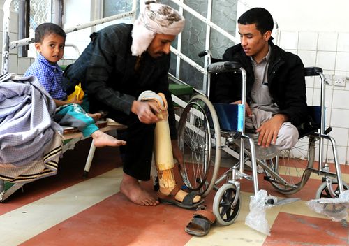 Men in Sana'a with amputated legs wait for their a prosthetic limbs, on the third anniversary of the Yemen civil war. (Getty)