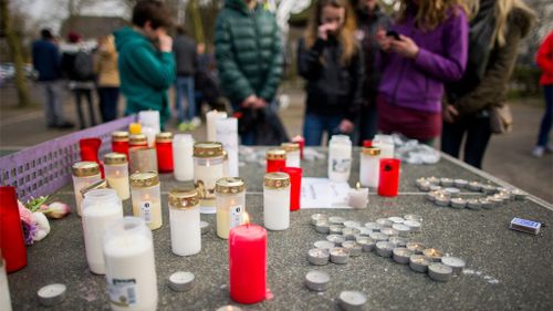 Candles are left outside the college as the children mourn their fellow students. (AAP)