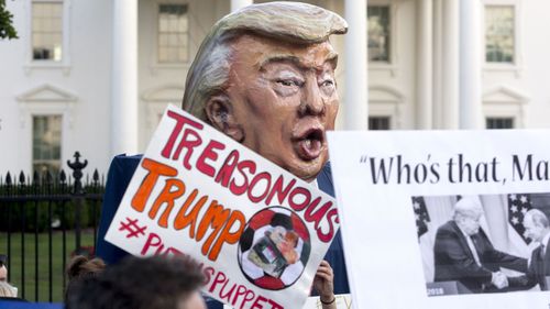 Protesters wield a Donald Trump puppet outside the White House. (AAP)