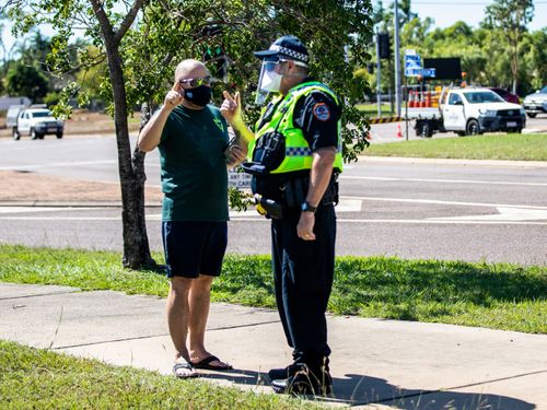 A man talks to a policeman outside a COVID-19 testing station at Marrara Sport Complex in Darwin.