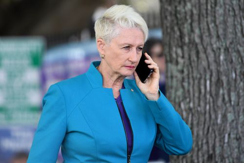ndependent candidate for Wentworth Kerryn Phelps is seen on the phone while handing out how to vote cards at a polling place at Bellevue Hill.