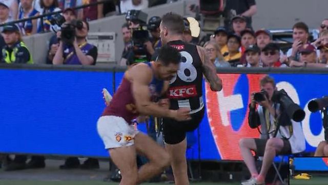 Lions star Charlie Cameron puts his shoulder into Pies defender Jeremy Howe.