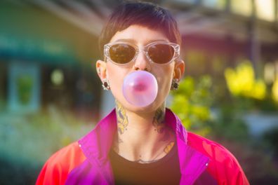 Beautiful woman Woman blowing bubble gum balloon