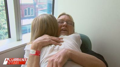 Chloe Lattanzi embraces one of the  patients at the The Olivia Newton-John (ONJ) Wellness Centre.