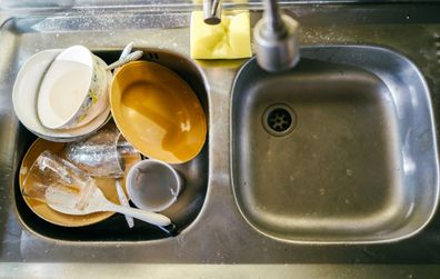 Dirty dishes in the house kitchen sink in evening