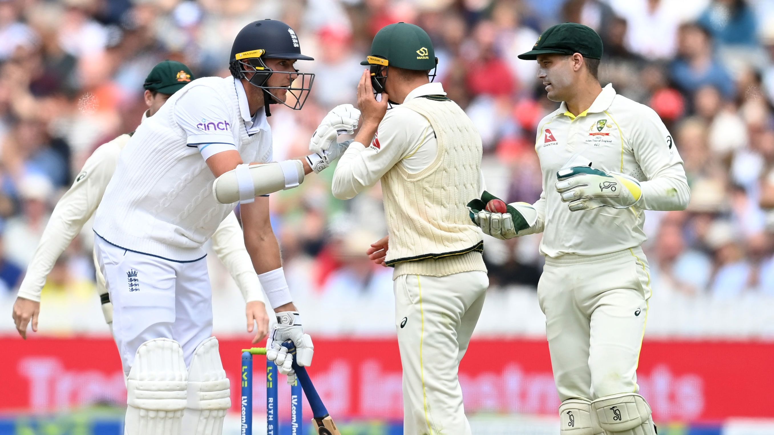 Stuart Broad of England grounds his bat while looking at Marnus Labuschagne and Alex Carey of Australia during day five of the Ashes Test at Lord&#x27;s.