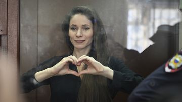 Antonina Favorskaya stands in a glass cage in a courtroom in the Basmanny District Court in Moscow, Russia, Friday, March 29, 2024.
