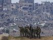 Israeli female soldiers pose for a photo on a position on the Gaza Strip border, in southern Israel, Monday, Feb. 19, 2024. 