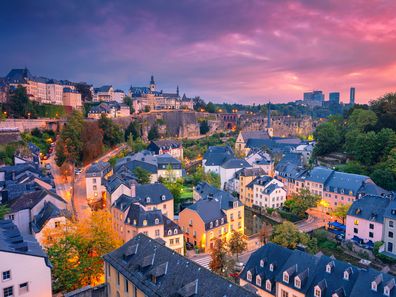 Aerial cityscape image of old town Luxembourg City skyline during beautiful sunrise.