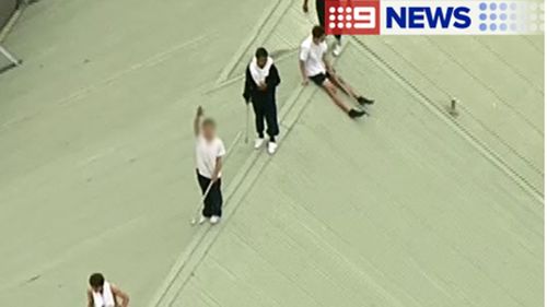 At least six inmates have climbed on top of one of the accommodation buildings at the Parkville youth justice centre. (9NEWS)