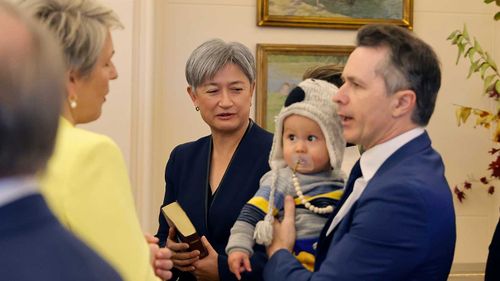 Newly sworn in ministers Tanya Plibersek, Penny Wong and Jason Clare - holding his baby Atticus.