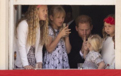 Prince Harry with Savannah Phillips and Mia Tindall in the  Major General's office overlooking The Trooping of the Colour on Horse Guards Parade.