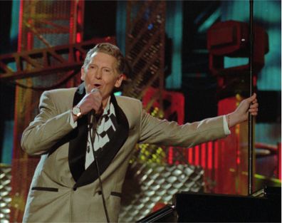 Jerry Lee Lewis performs with Bruce Springsteen and the E Street Band at the Concert for the Rock and Roll Hall of Fame in 1995. 