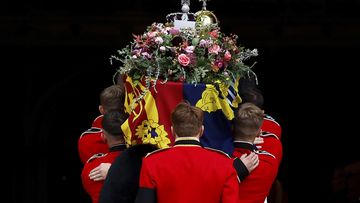 Pall bearers carry the coffin of Queen Elizabeth II with the Imperial State Crown resting on top into St. George&#x27;s Chapel, in Windsor, England, Monday, Sept. 19, 2022, for the committal service for Queen Elizabeth II. (Jeff J Mitchell/Pool Photo via AP)