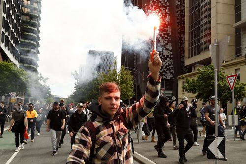 MELBOURNE, AUSTRALIA - SEPTEMBER 22: Protesters are seen walking through Melbourne CBD on September 22, 2021 in Melbourne, Australia. Protests started on Monday over new COVID-19 vaccine requirements for construction workers but  turned into larger and at times violent demonstrations against lockdown restrictions in general. Melbourne is currently subject to COVID-19 lockdown restrictions, with people only permitted to leave home for essential reasons. (Photo by Darrian Traynor/Getty Images)