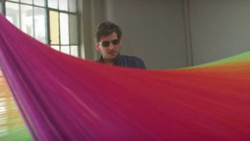 A man sees new colours for the first time wearing EnChroma glasses. (Valspar Corporation)