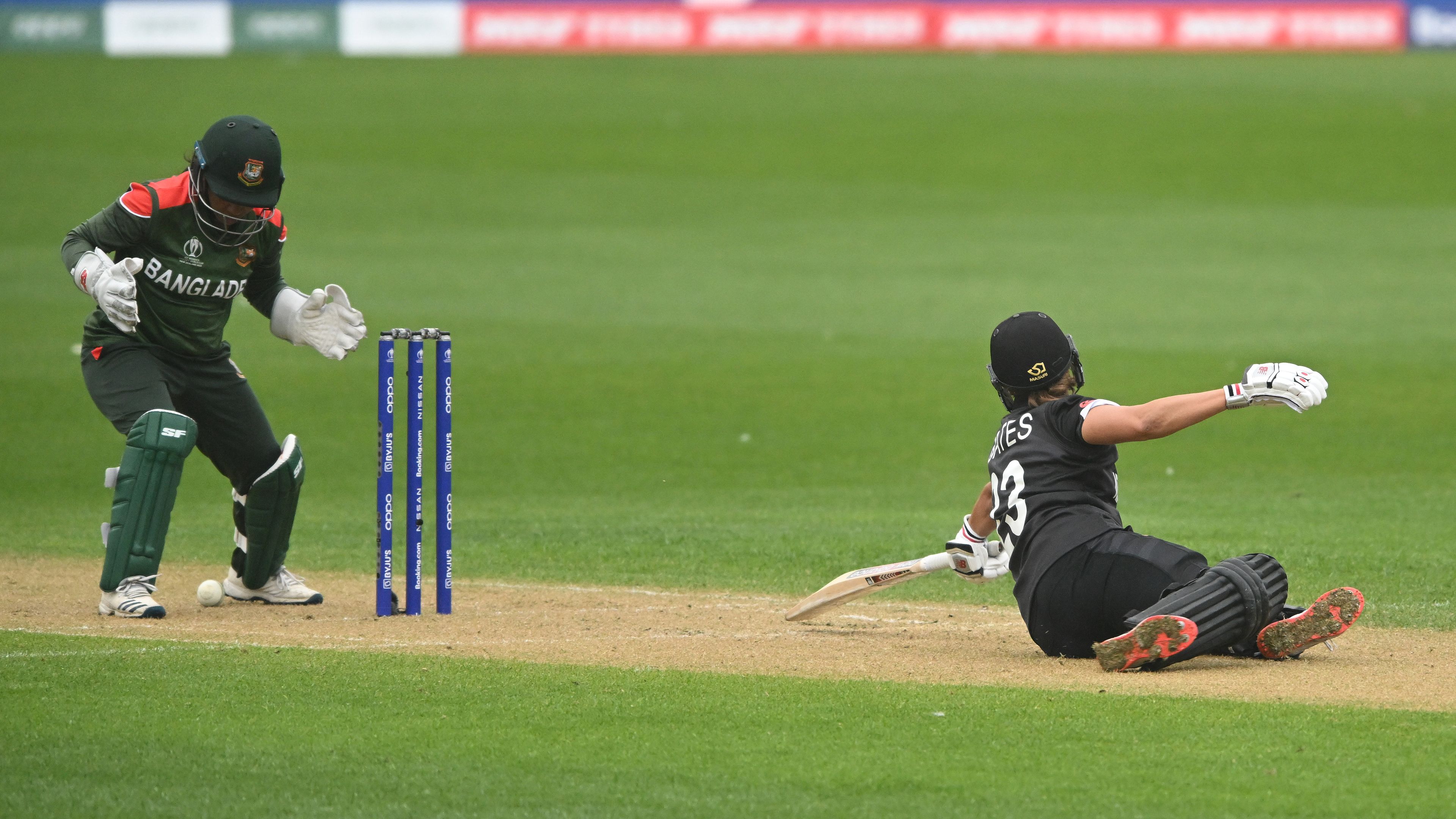 Suzie Bates of New Zealand falls to ground as Shamima Sultana of Bangladesh attempts to stump during the 2022 ICC Women&#x27;s Cricket World Cup.
