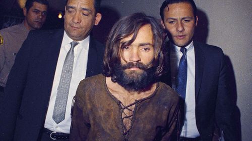 Charles Manson is escorted to his arraignment on conspiracy-murder charges in connection with the Sharon Tate murder case in Los Angeles in 1969.