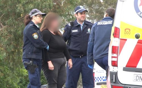 The shocked grandmother is helped into an ambulance. Picture: 9News
