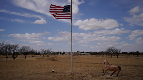 A flag flies at half staff at the University of the Southwest, Thursday, March 17, 2022, in Hobbs, New Mexico. 