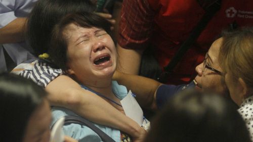 Relatives distraught as bodies found in AirAsia flight search