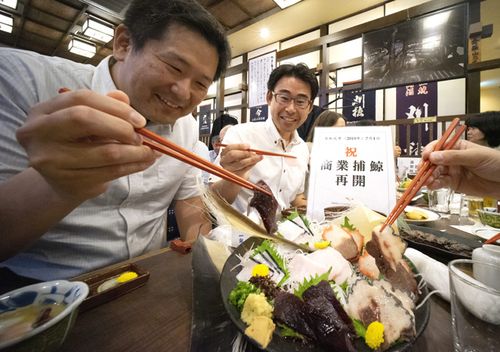 People enjoy eating whale dishes at a restaurant in Tokyo, Japan