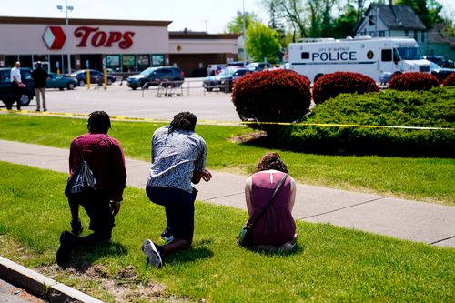 People pray outside the supermarket in Buffalo.