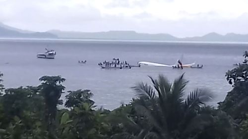 The plane in the ocean after overshooting the runway in Micronesia close to Papua New Guinea.