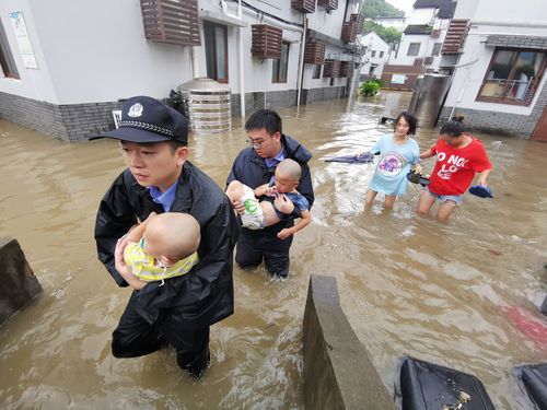 Chinese rescuers evacuate babies in floodwater after heavy rainstorm caused by Typhoon Lekima.