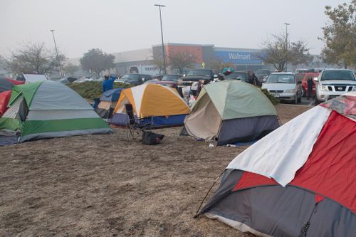 Some evacuees remain at an informal shelter outside a Walmart store in Chico.