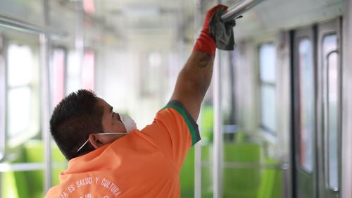 A workers disinfects a metro train car during a cleaning day at in Mexico City, Mexico.