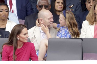 Mia Tindall gives dad Mike Tindall a hug as they watch the Platinum Jubilee Pageant outside Buckingham Palace in London, Sunday June 5, 2022.