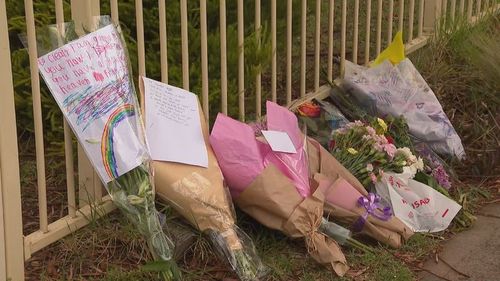 Flower tributes, notes and drawings were placed outside the Tullamarine home.
