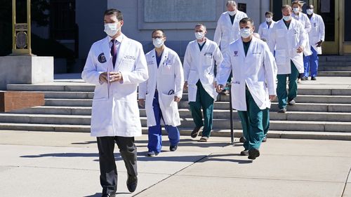 Dr Sean Conley, physician to President Donald Trump, is followed by a team of doctors for a briefing with reporters at Walter Reed National Military Medical Centre. (AP Photo/Susan Walsh)