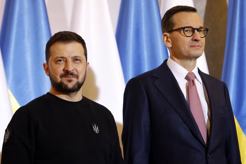 Poland's Prime Minister Mateusz Morawiecki, right, welcomes Ukrainian President Volodymyr Zelenskyy as they meet in Warsaw, Poland, Wednesday, April 5, 2023. 