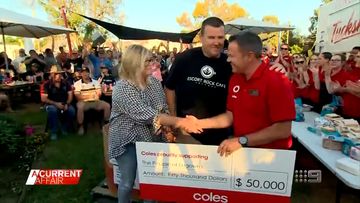 Tracy presents $50,000 Coles donation to flood-ravaged community