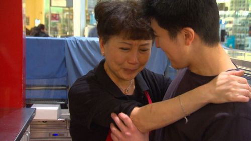 Distraught former franchisee Jenny Teng with her son.