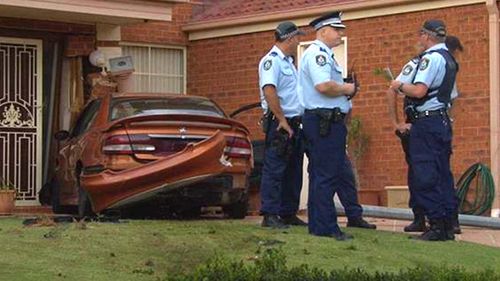 Men charged after car crashes into home