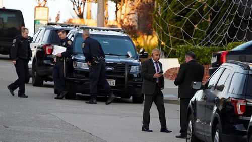 Police investigators work outside the home of House Speaker Nancy Pelosi in San Francisco.