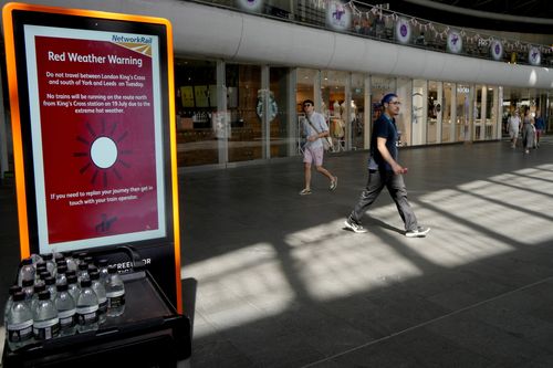 A sign at King's Cross railway station warns of train cancellations due to the heat in London, July 19, 2022. 